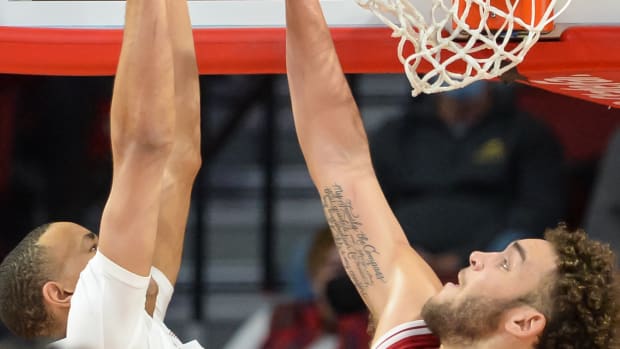 Race Thompson tries to block a dunk.